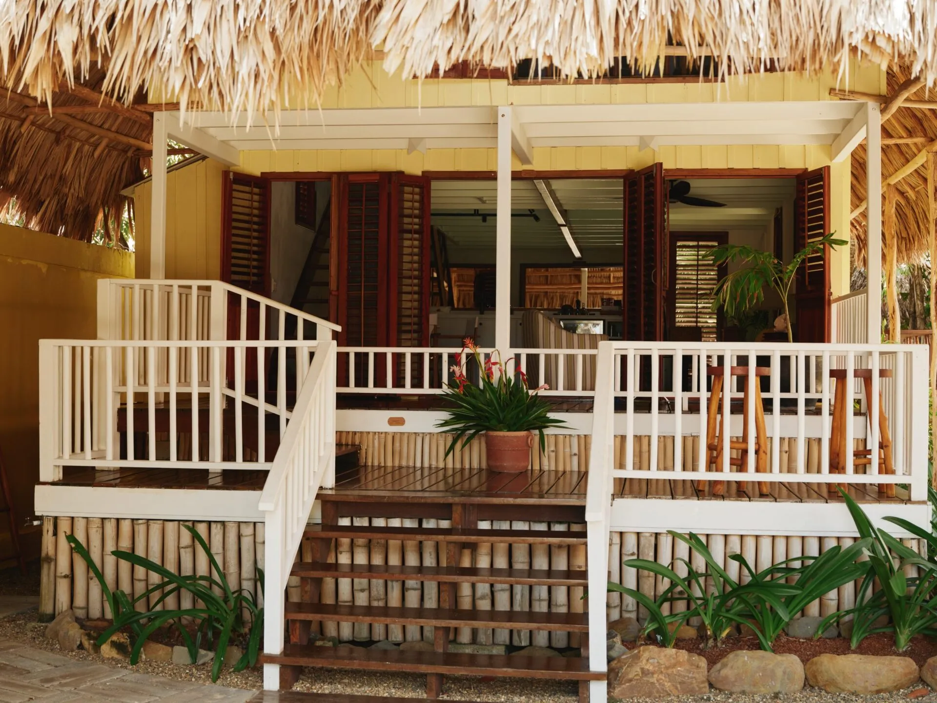 exterior of stella's starfish cottage on the beach at turtle inn, placencia, belize