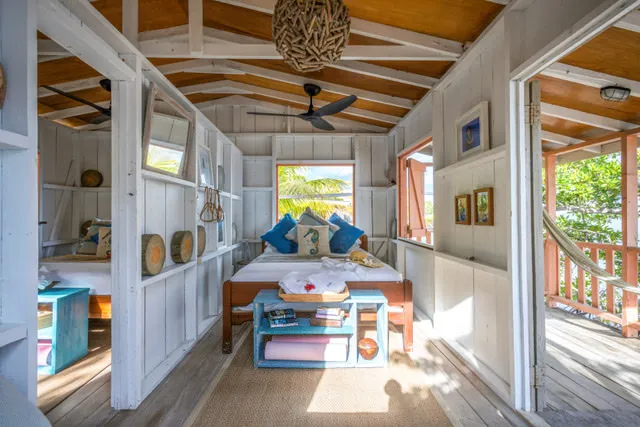 A colorful bedroom with wood paneled walls