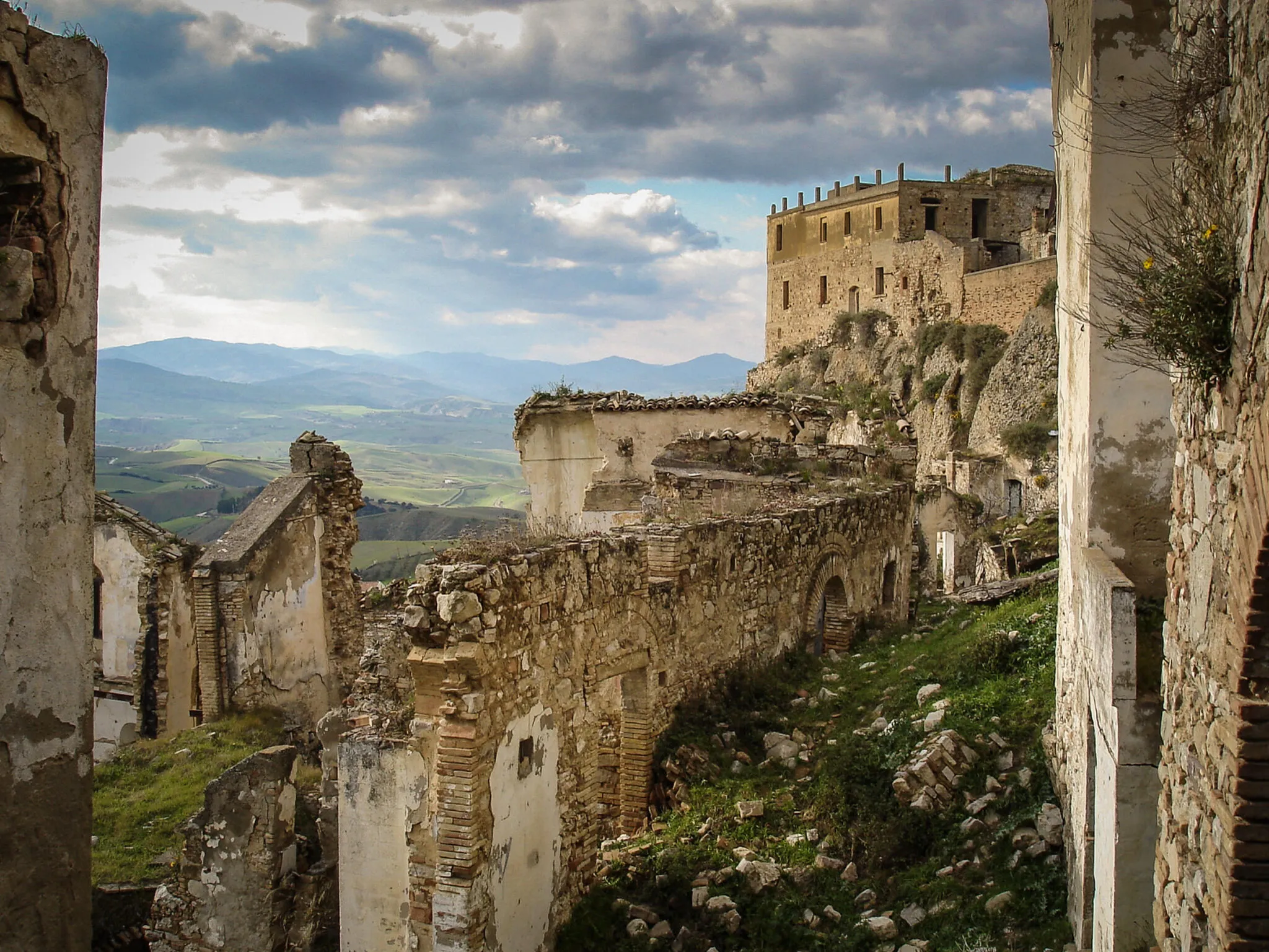 Crumbling stone walls on the Craco hillside