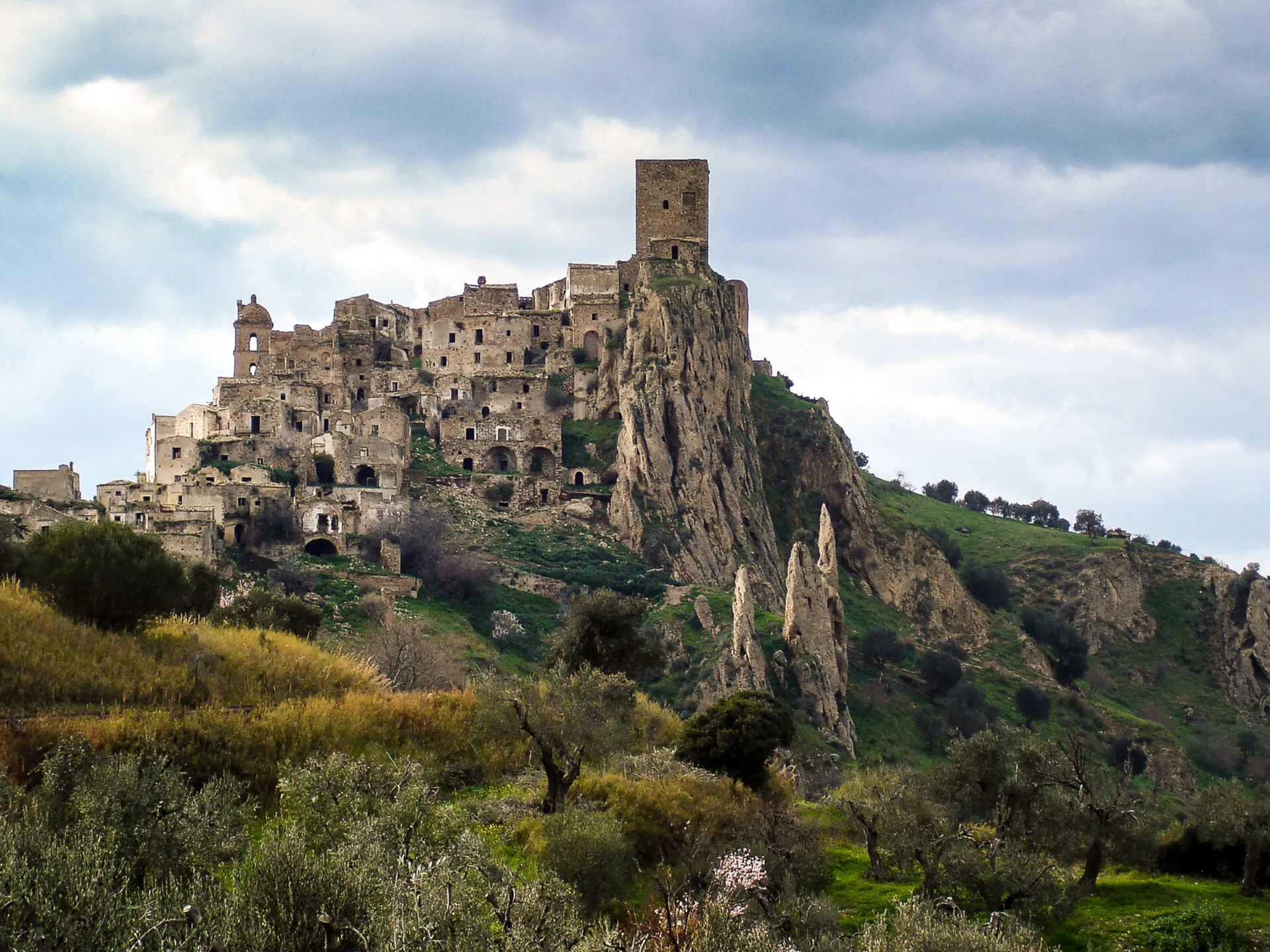 Stone buildings surrounding a castle at Craco