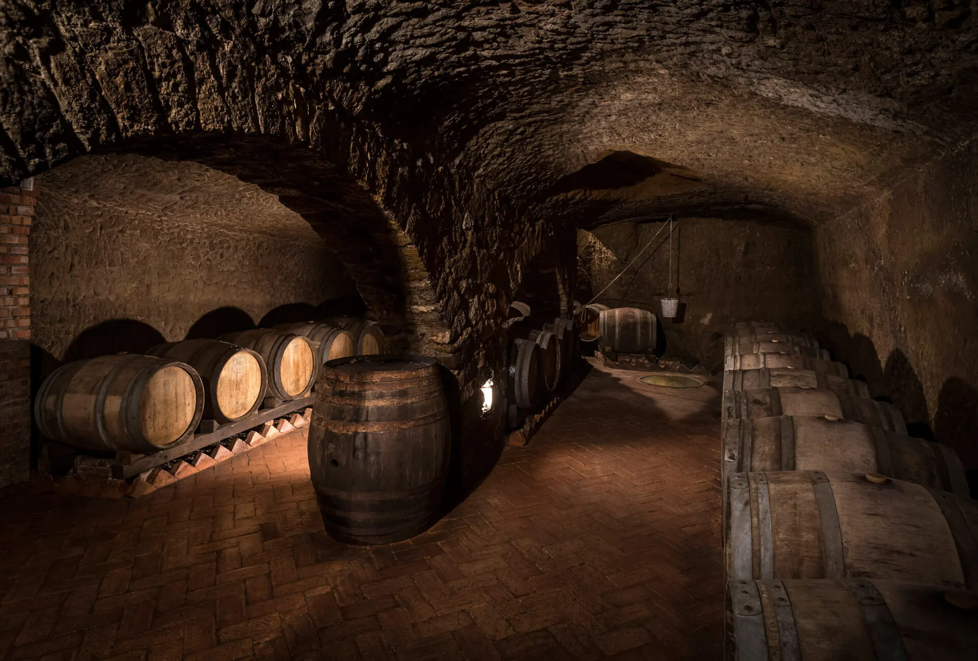 Wine barrels in cellar with stone walls