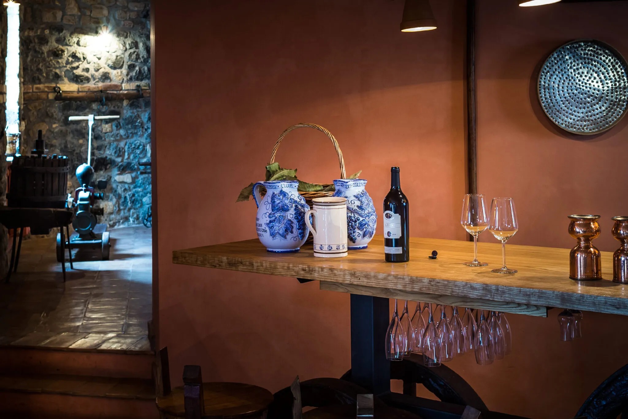 Open bottle of wine with two glasses on a table