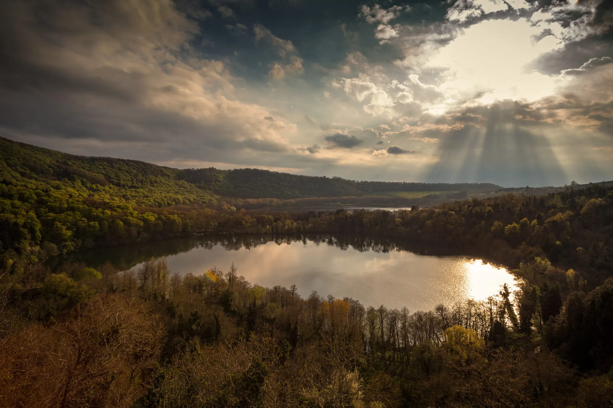 Sun shining through the clouds over Monticchio Lakes