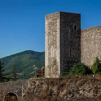 Brick building with tower on a hillside at Melfi