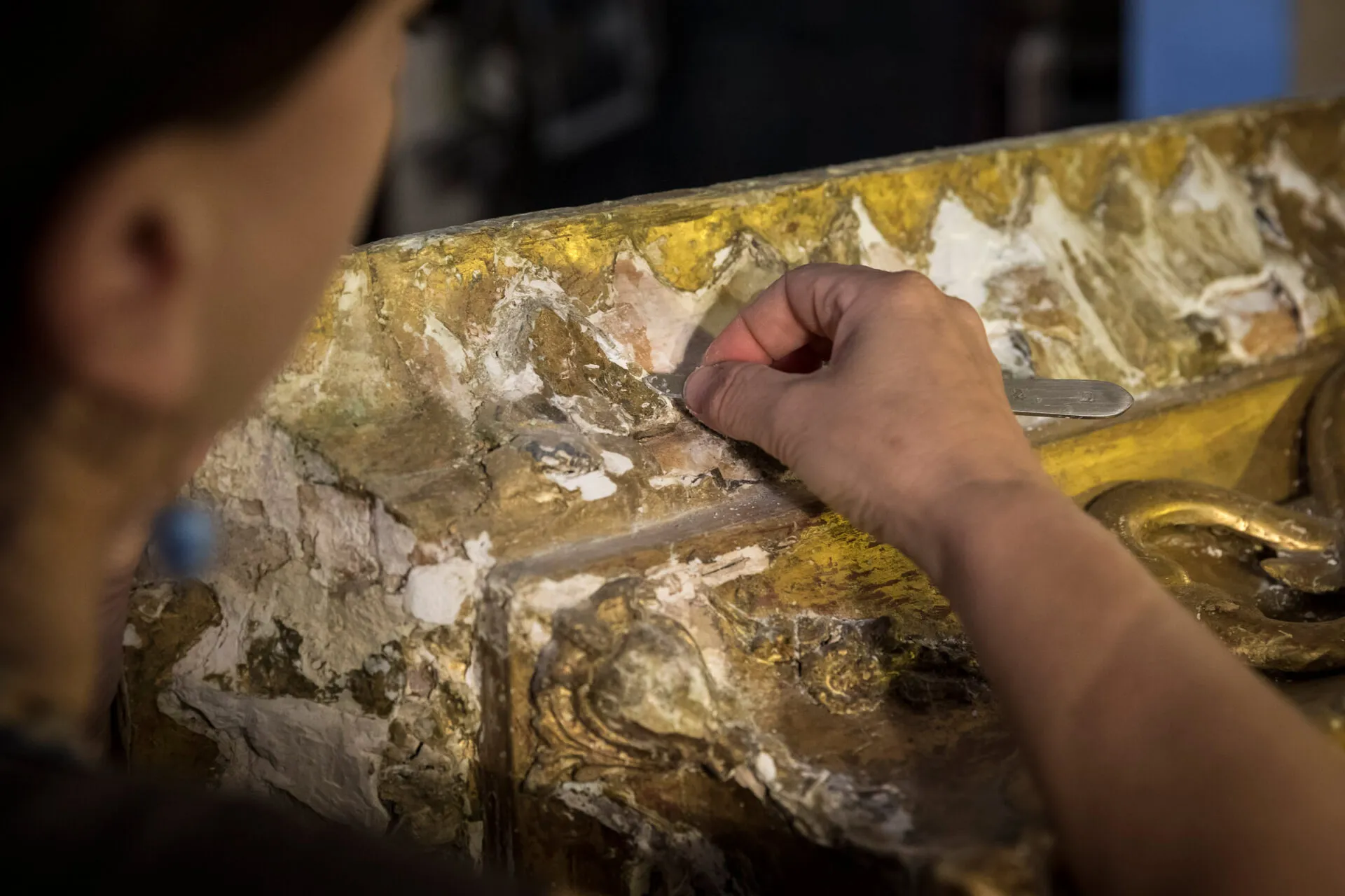 close up of an artisan restoring a work