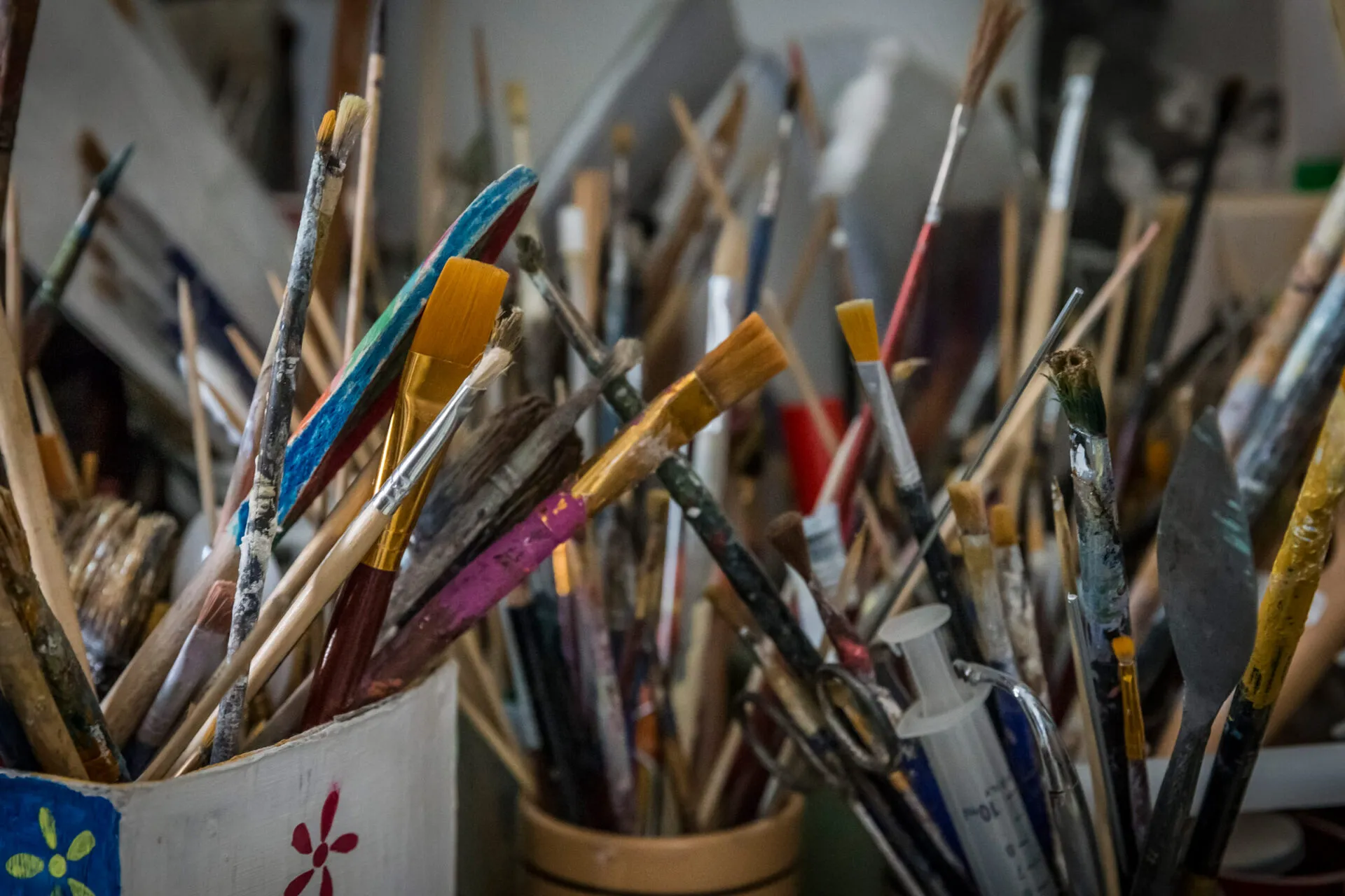 cups full of paintbrushes and restoration tools
