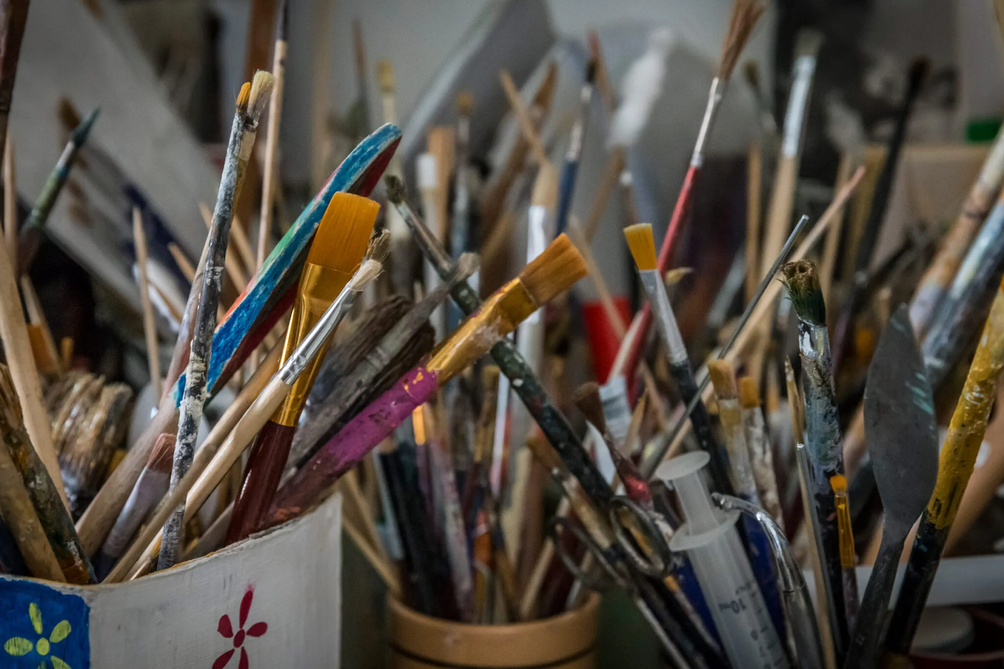 cups full of paintbrushes and restoration tools