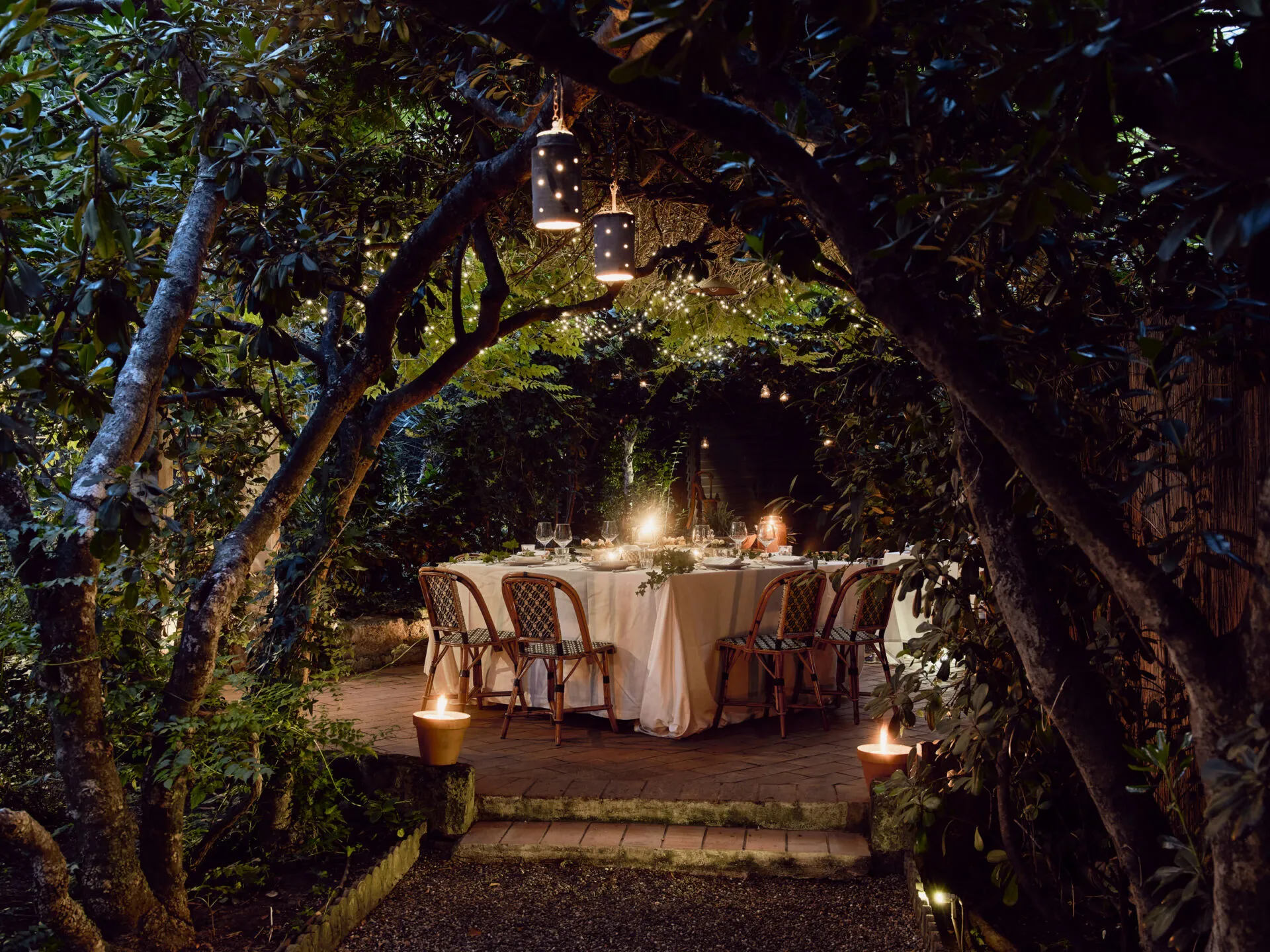 A dining table in the garden at night