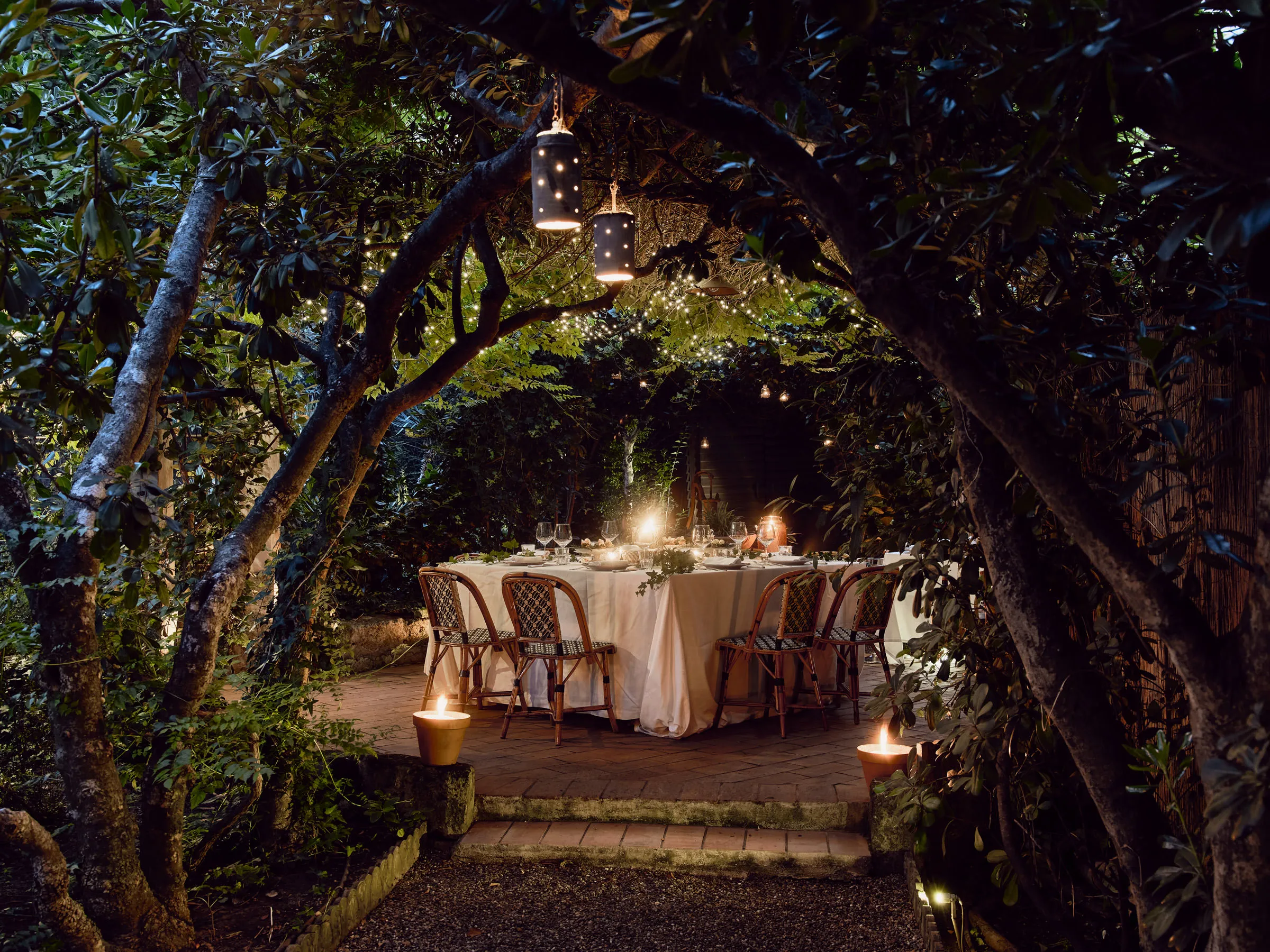 A dining table in the garden at night