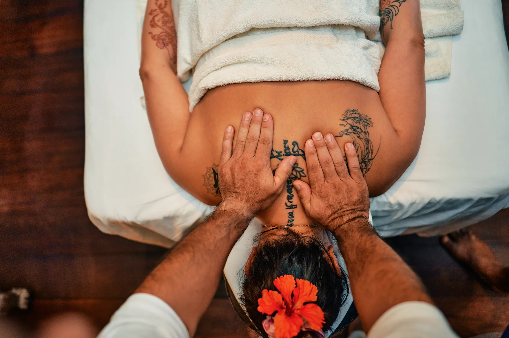 A woman having her shoulders rubbed by a massage therapist