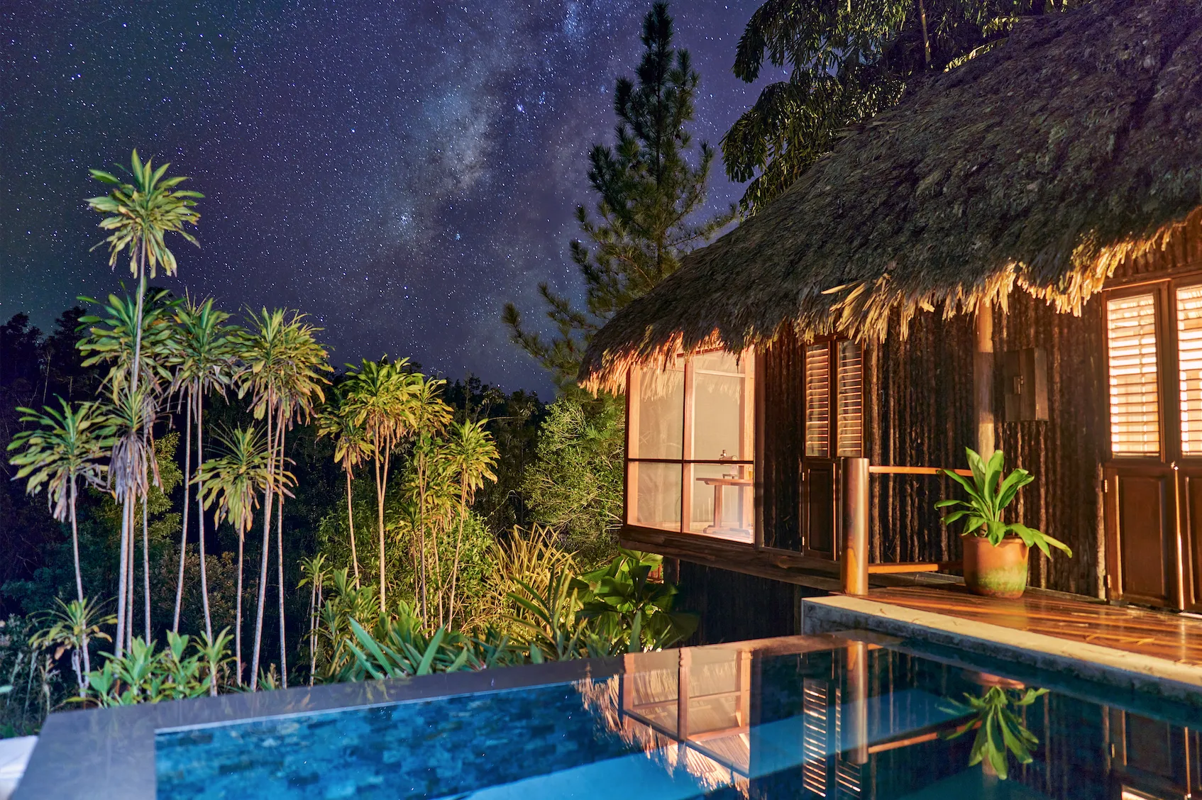 The cabana and its pool under a starlit sky