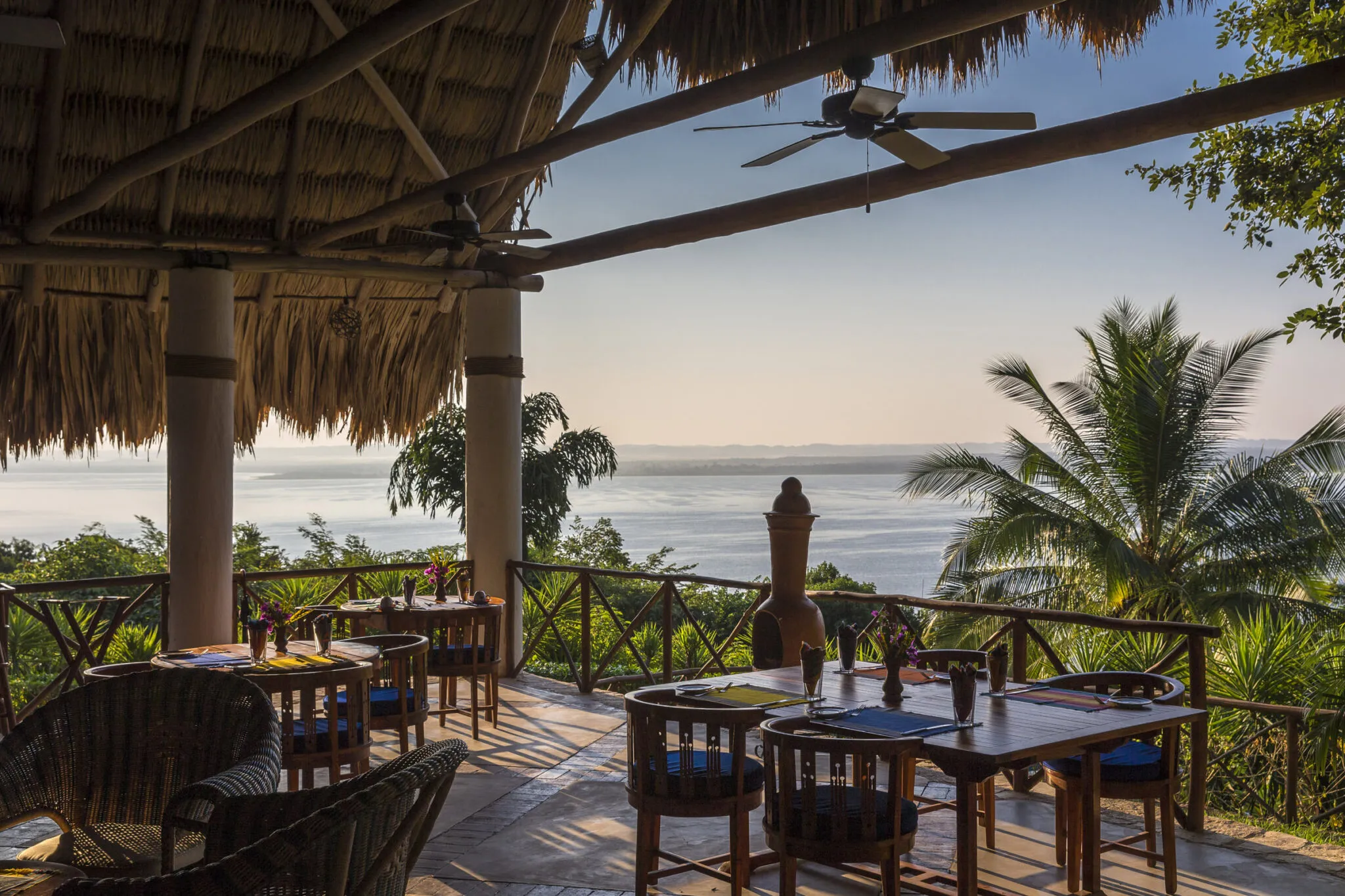 A corner of a deck with table seating at the main lodge at La Lancha.