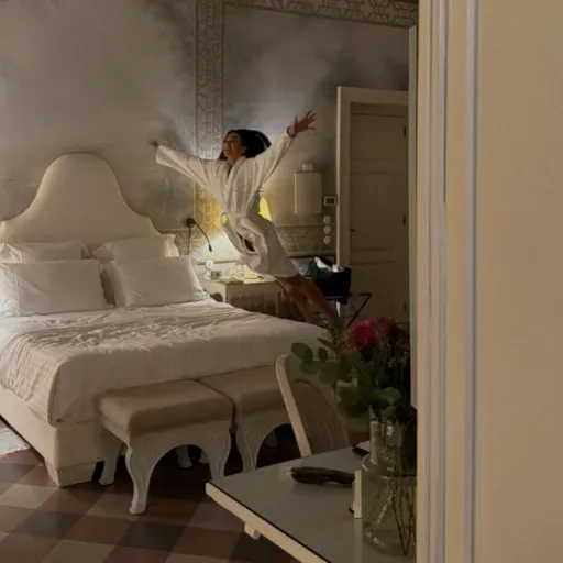 Dua Lipa jumping on bed in Sofia's Suite at Palazzo Margherita during her honeymoon